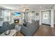 Cozy living room with fireplace, TV, windows and ceiling fan provides a relaxing and comfortable space at 414 Hamlet Cir, Goose Creek, SC 29445