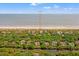 Coastal home '43 Surfsong' aerial view showcasing proximity to the beach and tranquil waterway, surrounded by lush greenery at 43 Surfsong Rd, Kiawah Island, SC 29455