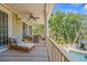 Serene porch with comfortable seating overlooking the pool and lush green landscape at 43 Surfsong Rd, Kiawah Island, SC 29455