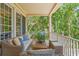 Relaxing back porch featuring comfortable seating and a view of the lush, green surroundings at 43 Surfsong Rd, Kiawah Island, SC 29455
