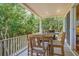 Charming covered back porch with dining area and scenic views of the surrounding lush greenery at 43 Surfsong Rd, Kiawah Island, SC 29455