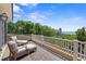 Outdoor seating on the spacious balcony with stunning ocean views and lush trees at 43 Surfsong Rd, Kiawah Island, SC 29455