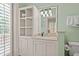 Bright bathroom featuring built-in storage, vanity and a window with white shutters at 43 Surfsong Rd, Kiawah Island, SC 29455