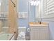 Well-lit bathroom with a tiled shower, vanity with ample storage, and neutral color scheme at 43 Surfsong Rd, Kiawah Island, SC 29455