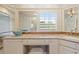 A vanity in a luxurious bathroom features a unique sink, marble countertop and decorative wallpaper at 43 Surfsong Rd, Kiawah Island, SC 29455