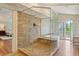 Luxurious bathroom boasts a glass-enclosed shower, soaking tub, and access to a private balcony at 43 Surfsong Rd, Kiawah Island, SC 29455