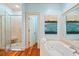Spacious bathroom with jacuzzi tub and large glass shower features natural stone and modern fixtures at 43 Surfsong Rd, Kiawah Island, SC 29455