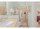 Bathroom featuring neutral tiling, glass enclosed shower and stone vanity at 43 Surfsong Rd, Kiawah Island, SC 29455