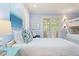 Bright bedroom featuring hardwood floors, a bunk bed, and a blue accent chair near large windows at 43 Surfsong Rd, Kiawah Island, SC 29455