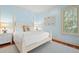 Cozy bedroom features a four-poster bed, hardwood floors, and soothing, light-blue painted walls at 43 Surfsong Rd, Kiawah Island, SC 29455