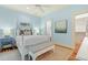 Serene bedroom with a four-poster bed, soft blue walls, and an adjacent bathroom and closet at 43 Surfsong Rd, Kiawah Island, SC 29455