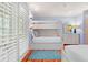 Spacious bedroom features hardwood floors, a bunk bed, and a dresser with a light-blue mirror at 43 Surfsong Rd, Kiawah Island, SC 29455