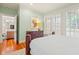 Well-lit bedroom featuring a wood bed frame, light green walls, and access to the living room at 43 Surfsong Rd, Kiawah Island, SC 29455