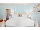 Bright bedroom with a four-poster bed, bedside tables with lamps and light-blue walls at 43 Surfsong Rd, Kiawah Island, SC 29455