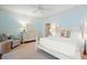 Bright bedroom offering a bed with end tables, ceiling fan and sitting chair at 43 Surfsong Rd, Kiawah Island, SC 29455