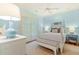 Cozy bedroom with light blue walls, plantation shutters, and a comfortable four-poster bed at 43 Surfsong Rd, Kiawah Island, SC 29455