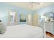 Bright bedroom showcasing a four-poster bed, light blue accents, and access to an en-suite bathroom and closet at 43 Surfsong Rd, Kiawah Island, SC 29455