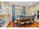 Bright dining area features a wood table, black chairs, and natural light from the large window at 43 Surfsong Rd, Kiawah Island, SC 29455
