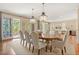 Elegant dining room featuring a wood table, seating for eight, and access to an outdoor balcony at 43 Surfsong Rd, Kiawah Island, SC 29455