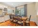 The dining room shows an expansive wood table and chairs, a window and built-in shelves at 43 Surfsong Rd, Kiawah Island, SC 29455