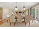 Bright dining room with an eight-seat table, overhead lights, and glass doors opening to the outdoor patio at 43 Surfsong Rd, Kiawah Island, SC 29455