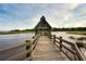 Picturesque wooden dock leading to a quaint building over the calm water at 43 Surfsong Rd, Kiawah Island, SC 29455