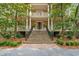 Stately raised home with a brick staircase leading to a welcoming front porch and beautifully landscaped grounds at 43 Surfsong Rd, Kiawah Island, SC 29455