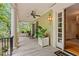 Spacious front porch with rocking chairs, ceiling fan, and stylish lantern lighting at 43 Surfsong Rd, Kiawah Island, SC 29455