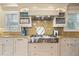 Gourmet kitchen with stainless steel appliances, custom cabinetry, and a granite countertop backsplash at 43 Surfsong Rd, Kiawah Island, SC 29455