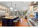 Open kitchen layout featuring a large center island with sink, bar stools and stainless steel appliances at 43 Surfsong Rd, Kiawah Island, SC 29455