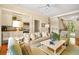 Comfortable living room with built-in wet bar, ceiling fan, hardwood floors, and neutral color palette at 43 Surfsong Rd, Kiawah Island, SC 29455