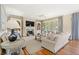 Spacious living room featuring a fireplace, built-in shelves, hardwood floors, and elegant furnishings, creating a welcoming atmosphere at 43 Surfsong Rd, Kiawah Island, SC 29455