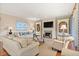 Bright living room featuring a fireplace, built-in shelves, hardwood floors, and stylish furnishings, exuding comfort and elegance at 43 Surfsong Rd, Kiawah Island, SC 29455