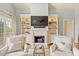 Cozy living room featuring built-in shelving, fireplace, and comfortable seating for relaxing evenings at 43 Surfsong Rd, Kiawah Island, SC 29455