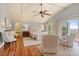 The bedroom features a ceiling fan and natural light, with seating area and balcony access at 43 Surfsong Rd, Kiawah Island, SC 29455