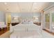 The main bedroom is bright and features wood floors, access to the bathroom, and a balcony at 43 Surfsong Rd, Kiawah Island, SC 29455