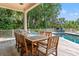Outdoor pool area with wooden deck, lounge chairs, and chess table overlooking the swimming pool at 43 Surfsong Rd, Kiawah Island, SC 29455