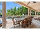 Inviting outdoor pool area with a chess table overlooking the swimming pool and beautiful greenery at 43 Surfsong Rd, Kiawah Island, SC 29455