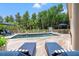 Beautiful backyard pool area with wooden deck, lounge chairs, and lush landscaping at 43 Surfsong Rd, Kiawah Island, SC 29455