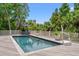 Sparkling pool surrounded by a spacious deck, featuring comfortable lounge chairs and a shaded seating area at 43 Surfsong Rd, Kiawah Island, SC 29455