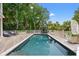 Backyard swimming pool and lounge area surrounded by a wooden deck and lush greenery at 43 Surfsong Rd, Kiawah Island, SC 29455
