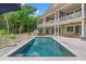 Backyard pool with deck and second story porch overlooking pool area and beautiful trees at 43 Surfsong Rd, Kiawah Island, SC 29455