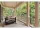 Relaxing porch swing on a covered balcony with views of mature trees at 43 Surfsong Rd, Kiawah Island, SC 29455