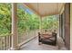 Comfortable porch swing is the perfect spot on the covered balcony to enjoy the view at 43 Surfsong Rd, Kiawah Island, SC 29455