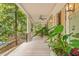 Spacious porch with elegant columns, outdoor lighting, and a scenic view of surrounding trees at 43 Surfsong Rd, Kiawah Island, SC 29455