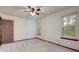 Comfortable bedroom with carpeted floors, three windows, and ceiling fan, perfect for restful nights at 436 Fox Hunt Rd, Goose Creek, SC 29445