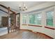 Open dining area with hardwood floors, a chandelier, and large windows, connected to the living room with a fireplace at 436 Fox Hunt Rd, Goose Creek, SC 29445