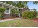 Charming brick home featuring a well-manicured lawn and inviting porch entrance at 436 Fox Hunt Rd, Goose Creek, SC 29445