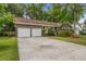 Spacious property with a two-car garage and a long driveway surrounded by lush trees at 436 Fox Hunt Rd, Goose Creek, SC 29445