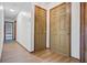 Inviting hallway with wood-look floors, multiple doors, and natural light streaming through at 436 Fox Hunt Rd, Goose Creek, SC 29445